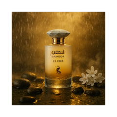Shahoor Elixir Perfume 100ml EDP with floral background and warm lighting against stones.