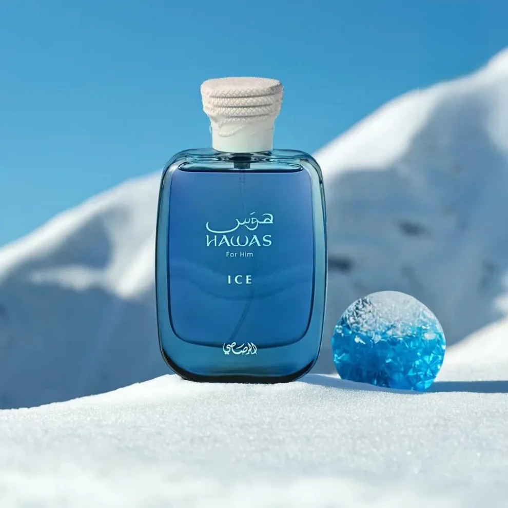 Rasasi Hawas ICE Perfume Spray for Him in a blue glass bottle, set against a snowy mountain backdrop.