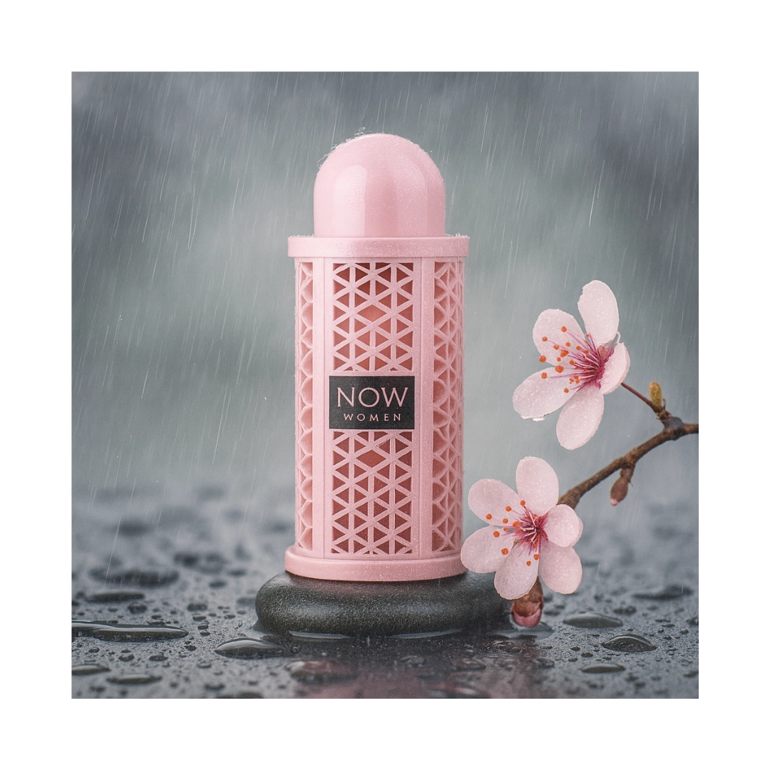 Now Women Rave 100ml EDP by Lattafa, elegantly displayed with pink flowers on a wet stone surface.
