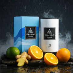 Jean Lowe Azure 100ml EDP in stylish packaging with citrus fruits and ginger on a stone surface.